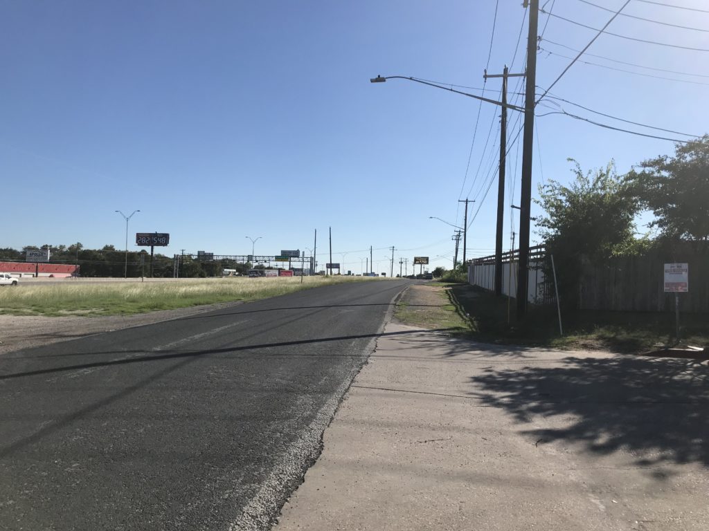 View of Middle Fiskville Road southbound approaching Grady